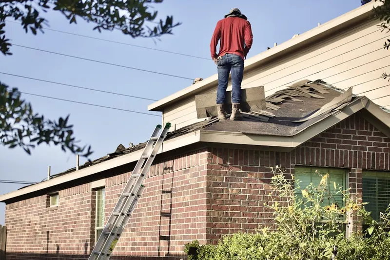 Professional roofer working on a residential roof in Eastman